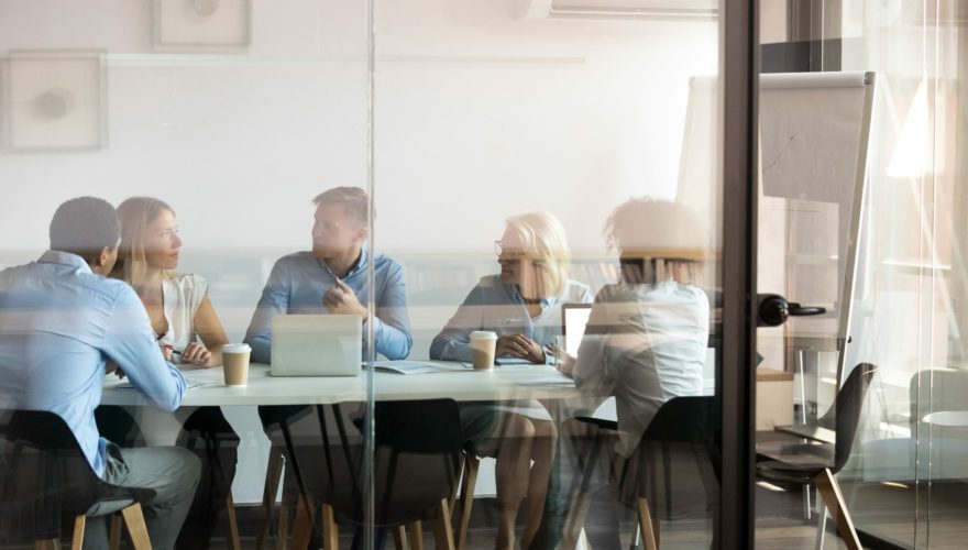 Business people negotiating at boardroom behind closed doors